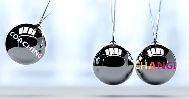 Coaching & Change written on Newton's cradle