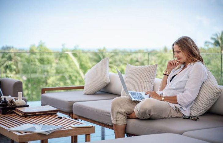 Woman using a laptop on a couch